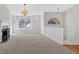 Spacious living room with fireplace, neutral carpet, and staircase to upstairs, well lit by large windows at 713 Shore Ln, Lithonia, GA 30058