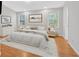 Cozy main bedroom featuring hardwood floors, natural light, and neutral decor at 713 Shore Ln, Lithonia, GA 30058