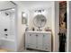 Bathroom featuring shower and tub combo, round mirror and sink with vanity at 1 Biscayne Nw Dr # 211, Atlanta, GA 30309