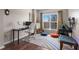 Bright bedroom featuring a desk, work space, and a large window with natural light at 1 Biscayne Nw Dr # 211, Atlanta, GA 30309