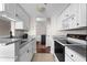 Modern kitchen featuring white cabinets, stainless steel appliances, and marble countertops at 1 Biscayne Nw Dr # 211, Atlanta, GA 30309