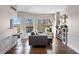 Bright living room features hardwood floors, large windows, and a cozy seating area at 1 Biscayne Nw Dr # 211, Atlanta, GA 30309