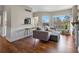 Open concept living space with hardwood flooring, stylish seating, and large windows at 1 Biscayne Nw Dr # 211, Atlanta, GA 30309