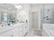 Bright bathroom features dual sinks with modern fixtures, a glass shower, and a soaking tub at 3260 Bennett Creek Ln, Suwanee, GA 30024