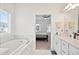 Luxurious bathroom with soaking tub and doorway to bedroom at 3260 Bennett Creek Ln, Suwanee, GA 30024