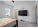 Well-lit bedroom with plush carpeting and mounted TV provides a relaxing space at 3260 Bennett Creek Ln, Suwanee, GA 30024