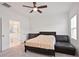 Well-lit bedroom with plush carpeting and an adjacent bathroom provides privacy at 3260 Bennett Creek Ln, Suwanee, GA 30024