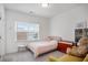 Cozy bedroom features a window, bedside table, and shelving at 3260 Bennett Creek Ln, Suwanee, GA 30024