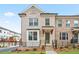 Charming brick townhome featuring a covered entrance, manicured lawn, and inviting curb appeal at 3260 Bennett Creek Ln, Suwanee, GA 30024
