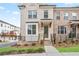 Charming brick townhome featuring a covered entrance, manicured lawn, and inviting curb appeal at 3260 Bennett Creek Ln, Suwanee, GA 30024
