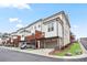 Exterior shot of townhomes each with a one-car garage and small deck above it at 3260 Bennett Creek Ln, Suwanee, GA 30024