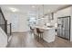 Modern kitchen with stainless steel appliances, white cabinetry, an island, and pendant lighting at 3260 Bennett Creek Ln, Suwanee, GA 30024