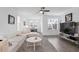 Bright living room features hardwood floors, a ceiling fan, and lots of natural light at 3260 Bennett Creek Ln, Suwanee, GA 30024