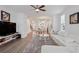 Open-concept living room flows into the dining area, featuring hardwood floors and neutral décor at 3260 Bennett Creek Ln, Suwanee, GA 30024