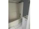 A clean bathroom features a combined tub and shower with a white vanity and sink at 5160 Avery St, Covington, GA 30014