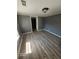 A freshly painted bedroom with new vinyl flooring, light-filled windows, and a modern ceiling light fixture at 5160 Avery St, Covington, GA 30014
