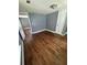 A sunny bedroom features hardwood floors, neutral paint and trim and a large closet at 5160 Avery St, Covington, GA 30014