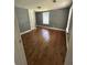 A sunny bedroom features hardwood floors, neutral paint and trim and a large closet at 5160 Avery St, Covington, GA 30014