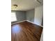 A sunny bedroom features hardwood floors, neutral paint and trim, and a large closet at 5160 Avery St, Covington, GA 30014