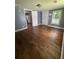 A sunny bedroom features hardwood floors, neutral paint and trim and a large closet at 5160 Avery St, Covington, GA 30014