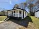 A quaint, newly renovated home featuring a welcoming front porch and fresh exterior paint with black and white trim at 5160 Avery St, Covington, GA 30014