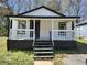 Charming single-story home featuring a welcoming front porch, black and white trim, and inviting curb appeal at 5160 Avery St, Covington, GA 30014