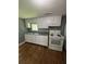 The kitchen features classic white cabinets, stainless steel sink, and a gas range at 5160 Avery St, Covington, GA 30014