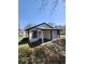 Rear view of a cozy home showcasing a covered porch and simple architecture against a clear blue sky at 5160 Avery St, Covington, GA 30014