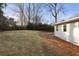 Large grassy backyard with mature trees, offering ample space for outdoor activities and relaxation at 1020 Pinedale Se Dr, Smyrna, GA 30080