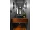 Modern powder room featuring a sleek, floating vanity and a large, well-lit mirror, offering a chic and contemporary space at 1020 Pinedale Se Dr, Smyrna, GA 30080