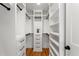 Organized walk-in closet with white shelving and drawers, providing ample storage and a clean, modern aesthetic at 1020 Pinedale Se Dr, Smyrna, GA 30080