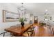 A spacious dining area with a wooden table and chairs, open to the bright living space at 1020 Pinedale Se Dr, Smyrna, GA 30080