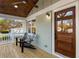 Inviting covered front porch with painted brick, wooden accents and stylish seating area at 1020 Pinedale Se Dr, Smyrna, GA 30080