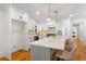 Beautiful kitchen with white cabinetry, quartz countertops, stainless steel appliances, and an island with seating at 1020 Pinedale Se Dr, Smyrna, GA 30080