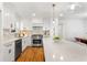 Modern kitchen with white cabinets, stainless steel appliances, and a spacious island with counter seating at 1020 Pinedale Se Dr, Smyrna, GA 30080