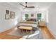 Bright primary bedroom featuring hardwood floors, a ceiling fan, and neutral decor at 1020 Pinedale Se Dr, Smyrna, GA 30080