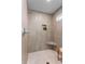 Stylish shower with neutral-toned tiles, corner seat, niche, and modern fixtures for a spa-like experience at 1020 Pinedale Se Dr, Smyrna, GA 30080