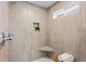 Stylish shower with neutral-toned tiles, corner seat, niche, and modern fixtures for a spa-like experience at 1020 Pinedale Se Dr, Smyrna, GA 30080
