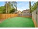 Backyard with fenced in yard, green turf and mature trees at 1126 Berkley Se Dr, Smyrna, GA 30082