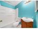 Bright bathroom with a tub-shower combo, single vanity, and blue walls at 1126 Berkley Se Dr, Smyrna, GA 30082