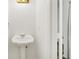 Cozy bathroom featuring a pedestal sink, bright lighting, and classic fixtures at 1126 Berkley Se Dr, Smyrna, GA 30082