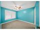 Bedroom with a ceiling fan, window with blinds, and blue walls at 1126 Berkley Se Dr, Smyrna, GA 30082