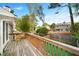 Wooden deck overlooks a fenced-in backyard area with turf, trees and home visible in the background at 1126 Berkley Se Dr, Smyrna, GA 30082
