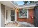 Entrance of the house with brickwork, storm door, and a window with security bars at 1126 Berkley Se Dr, Smyrna, GA 30082