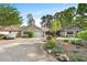 Charming home featuring a well-manicured front yard, two-car garage, and long driveway at 1126 Berkley Se Dr, Smyrna, GA 30082