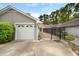 Garage exterior featuring a white garage door, and black fence to the entry way of the house at 1126 Berkley Se Dr, Smyrna, GA 30082