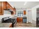 Open kitchen with stainless steel appliances, wooden cabinets and view of laundry area at 1126 Berkley Se Dr, Smyrna, GA 30082