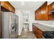 Long kitchen view with stainless steel refrigerator, granite countertops, and luxury vinyl flooring at 1126 Berkley Se Dr, Smyrna, GA 30082