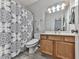 Bathroom featuring a sink, toilet, and a shower with a patterned curtain at 121 Riverwatch Ct, Canton, GA 30114