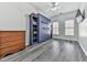 Bedroom with hardwood floors, a ceiling fan, and a large built-in bookcase at 121 Riverwatch Ct, Canton, GA 30114